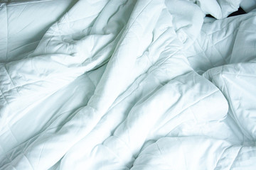 Top View Of White Blanket That Wrinkles On The Bed After Sleep In A Long Night.