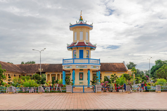 Cao Dai temple area and meditating followers of the Cao Dai religion in the temple Cao Dai, Tay Ninh, Vietnam