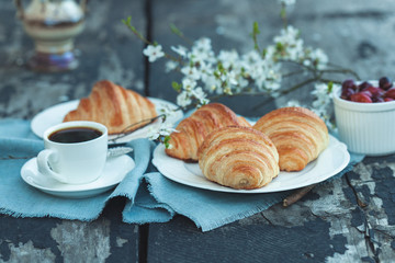Freshly backed croissants with berries and coffe