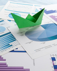 Paper boats on business charts. Business direction concept. 