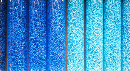 Blue candy in cylindrical display

