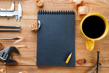 Work tools and notepad on a wooden floor. Construction concept.