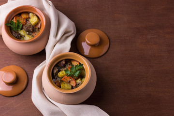 Two pots with stewed meat and potatoes