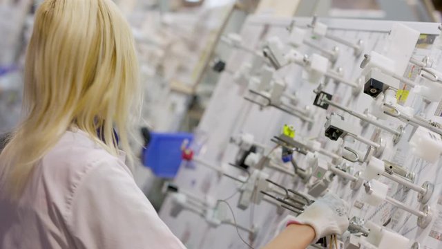 woman collects car cable at the stand