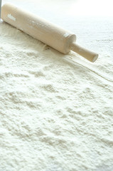 Flour and rolling pin on the table. Cook at home.