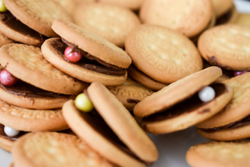 Close up of round biscuits filled with hazelnut spread and candy, South Africa