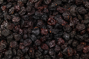 Plenty of dried grapes, dark raisins as a background