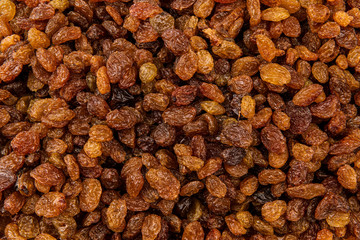Golden dried raisins as a background