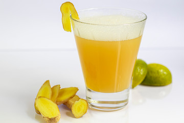 Fresh homemade ginger beer cocktail. Ice and lime on the table. On white background. Copy space.