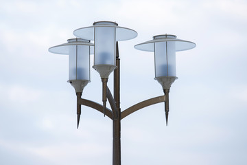 beautiful street lamps on a pillar against the sky. decorative decoration of urban space. street...