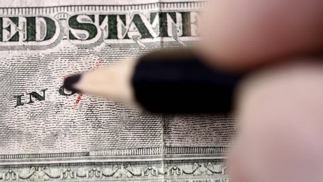 hand replacing the word god for science on on a US dollar bill. Suitable for science research, coronavirus vaccine or science as new relligion concepts.