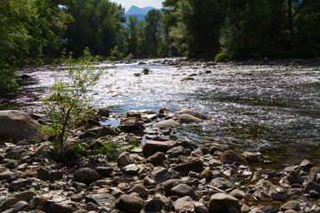 Mountain river with boulders in the riverbed