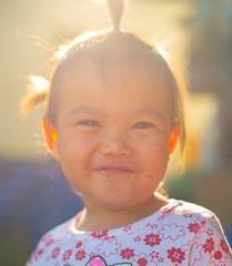 The face of an asian girl smiling with happiness