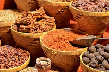 Fototapeta premium Rows & heaps of aromatic spices & herbs on display at the famous Spice Souk market in Baniyas Street, in locality of Al Ras, Deira, Dubai adjacent to the Gold Souk. It's a famous tourist destination