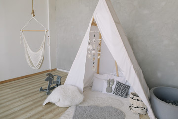 Nursery in Scandinavian style. Scandi child room interior in real photo. Decorative boho styled hut, tipi, wigwam © paralisart