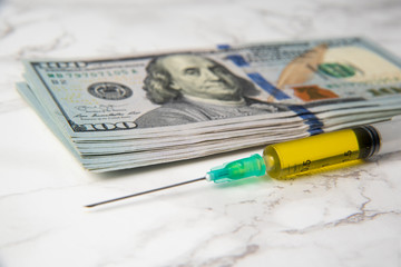 syringe and dollars. covid-19 vaccine