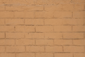 Fototapeta premium Yellow painted old brick wall abstract backgound