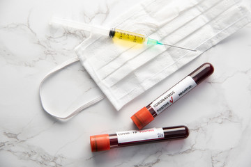 corona virus vaccine with blood sample and protection medical mask	