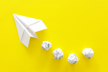education or innovation concept. paper origami plane over yellow background