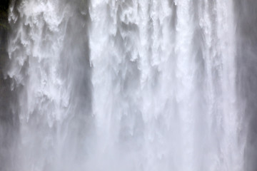 Skogafoss / Iceland - August 15, 2017: Beautiful and famous Skogafoss waterfall in South of Iceland, Iceland, Europe