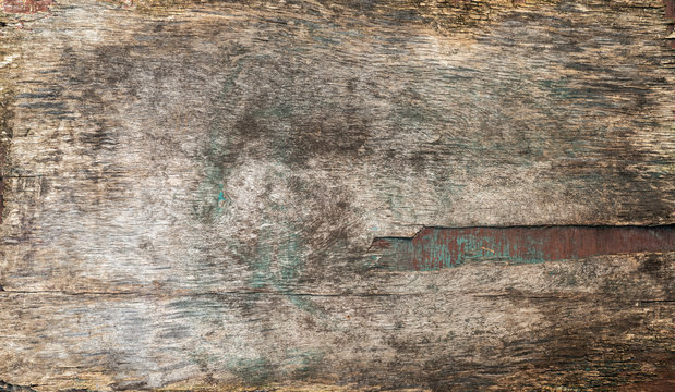Surface texture of old plywood with traces of paint in panoramic format.