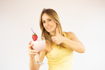 Pretty woman drinking having a strawberry smoothie