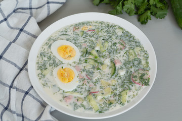 Cold summer soup okroshka. Cold soup with fresh cucumbers, radishes, potato and sausage. Traditional russian food okroshka. Summer cold soup.