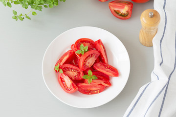 Tomato salad with basil and olive oil in bowl. Selective focus