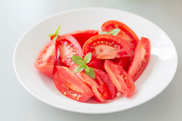 Tomato salad with basil and olive oil in bowl. Selective focus
