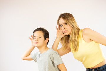 Mother and son making listening gesture