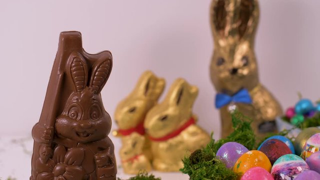 aster Eggs And Chocolate Bunnies On White Background.
