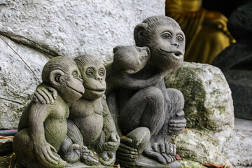 Fototapeta na wymiar Family of embracing stone monkeys