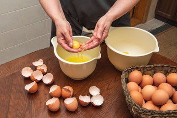 female hands separate the protein from the yolk. Egg yolk in the palms. Making homemade biscuit