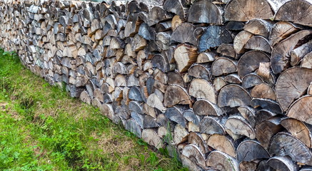 Woodpile of birch fire wood close up in the summer. (Background, banner, Wallpaper)