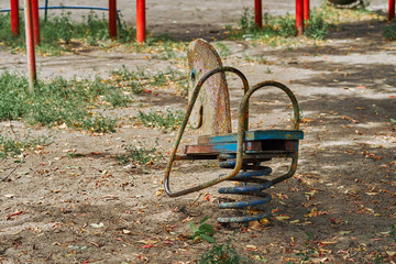 Old, shabby swing. Teddy-horse. Toy for children