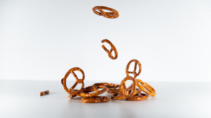 
Bretzels, delicious Alsatian salted cookies, falling in cascade, on white background