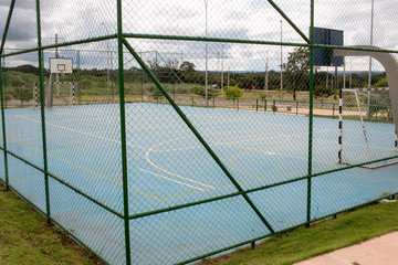 A Public Outdoor Basketball Court/Soccer Field stand Empty due to the Coronavirus Outbreak 
