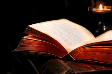 Old open book and candle