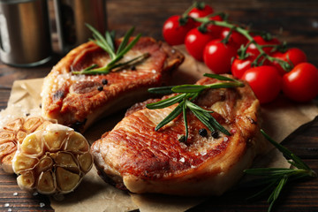 Composition with fried steaks on wooden background. Grilled food