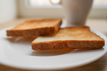 freshly baked toaster bread. Tasty toasted bread on wooden board. A couple of crusty toasts in the...