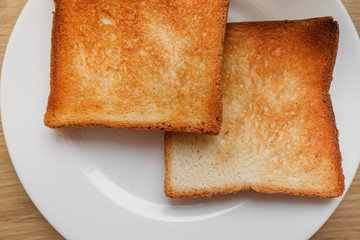 freshly baked toaster bread. Tasty toasted bread on wooden board. A couple of crusty toasts in the...