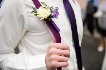 the groom holds on to a tightening
