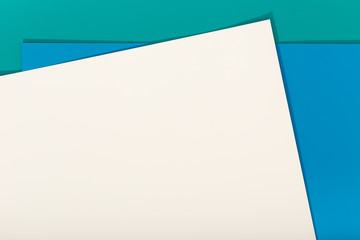 Abstract blue, green and beige color paper geometry composition background. Group of three color cardboard. Copy space