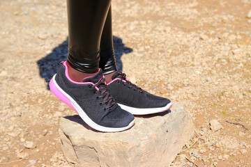 black sneakers on the stone