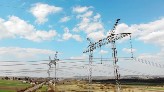 Aerial view Long-distance power transmission lines. High-voltage poles that efficiently transmit thousands of kilovolts of electricity between cities