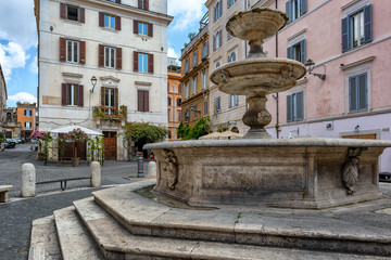 Fototapeta na wymiar Rome, Italy - The characteristic Piazza della Madonna Dei Monti with the ancient Catechumen Fountain, built in 1588.