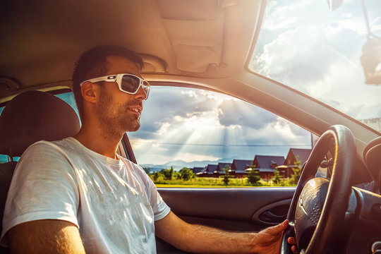 Attractive elegant happy man in a car.
