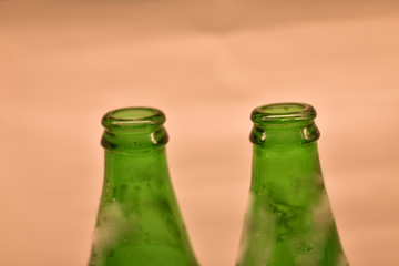 closeup of a green cold drink bottle with white background 