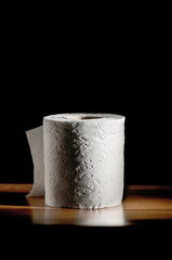 toilet paper roll on black background