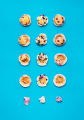 Eating muffins in steps. Fruit muffins top view